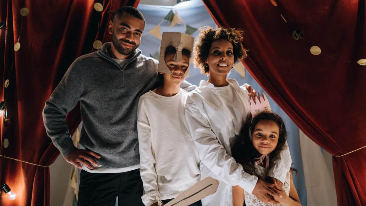 Family dressed up for a fun home theater activity, showcasing creativity and bonding.